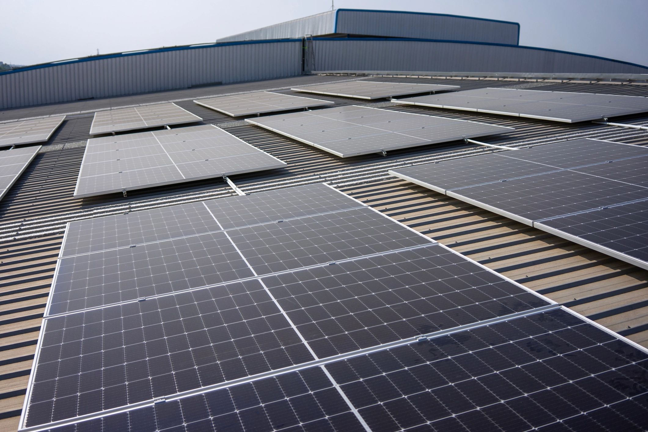 Illustrative solar panels on a factory rooftop